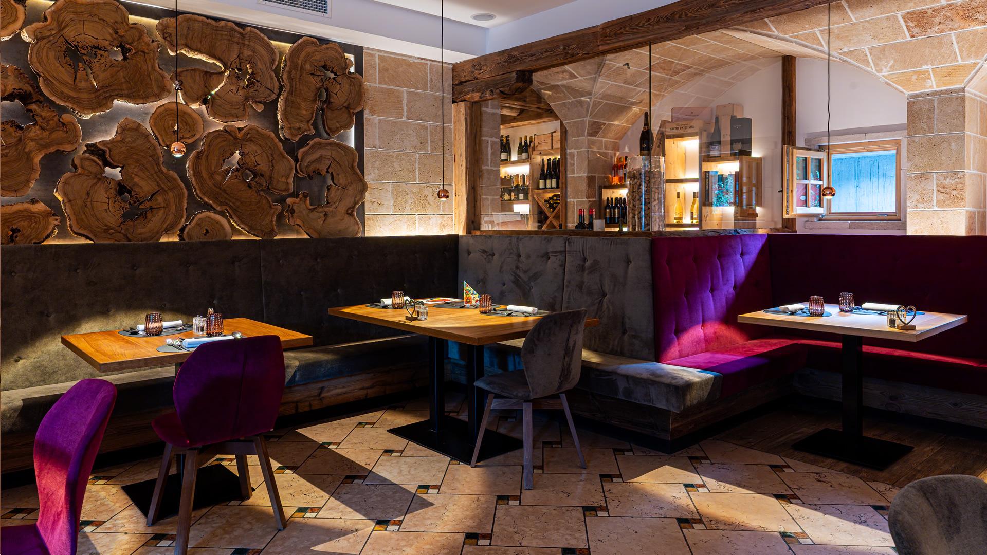 Elegante bar in legno con bancone curvo e sedie bianche.